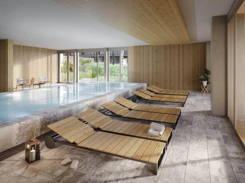 a swimming pool with a row of wooden mats in it at Marina Apartment am See mit Pool und Sauna in Bad Saarow