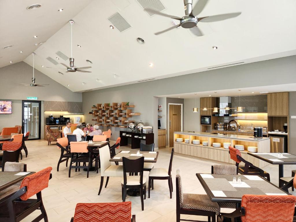 A bright dining room combines café-style tables with a built-in buffet or kitchen counter.
