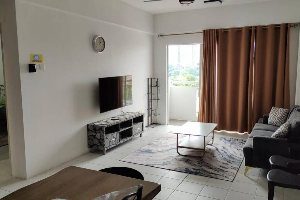 a living room with a couch and a tv at CANA Homestay Petaling Jaya in Petaling Jaya