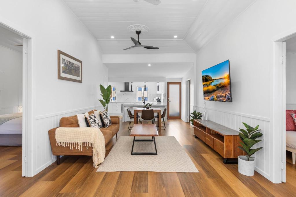 a living room with a couch and a table at Elegant 3-Bed 2-Bath Cottage: Classic Charm with a Modern Twist in Townsville