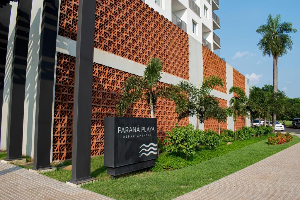 a building with a sign in front of it at Parana Playa 1103 in Encarnación