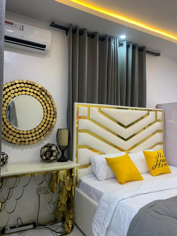 a bedroom with two beds and a mirror at Beautiful single room studio apartment in Ilasan lekki magnanimous in Lekki