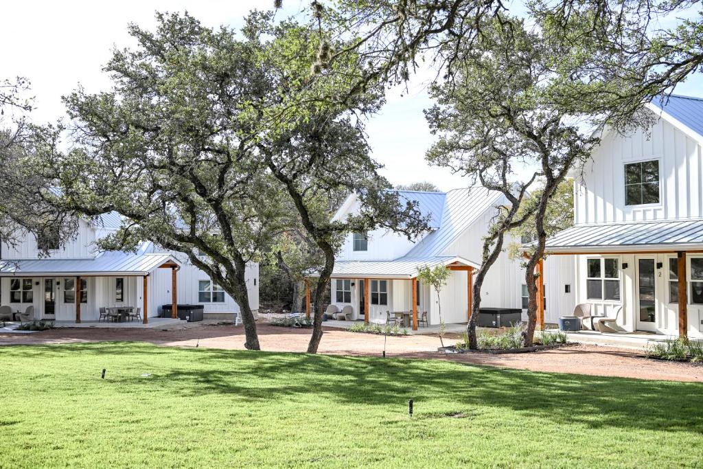 a white house with trees in the yard at Camp Hideaway Gruene in New Braunfels