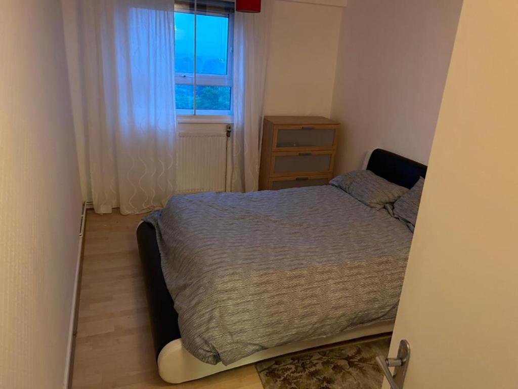 a small bedroom with a bed and a window at Normanton in Birmingham