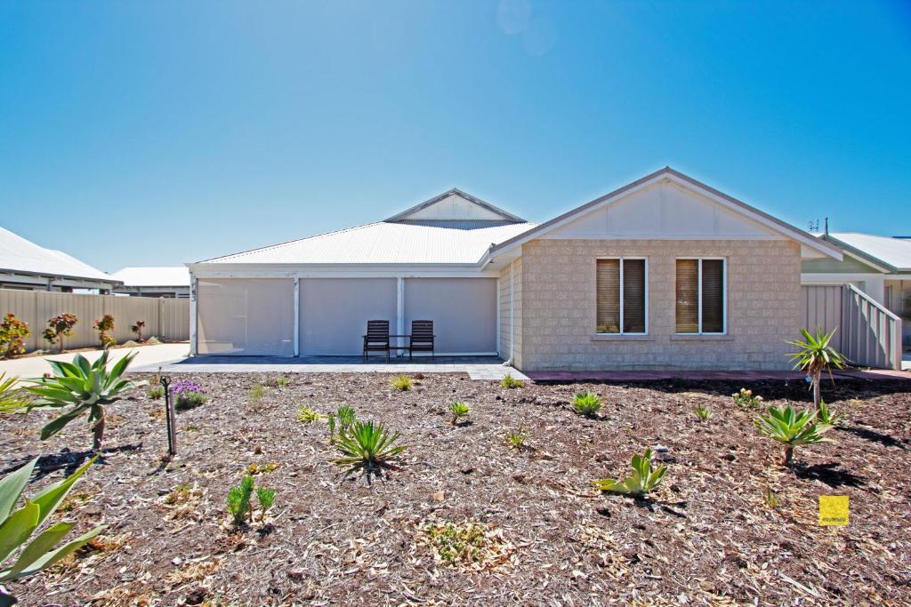 a house with a lot of plants in front of it at Fishface Retreat in Jurien Bay