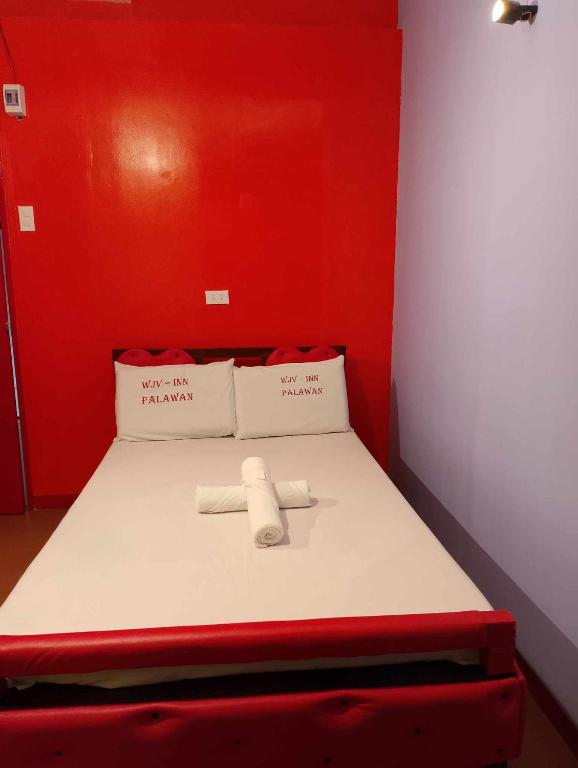 Postel nebo postele na pokoji v ubytování WJV INN PALAWAN