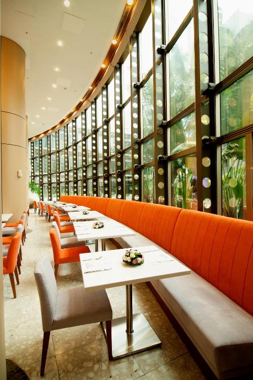 a row of tables in a restaurant with windows at Howard Civil Service International House in Taipei
