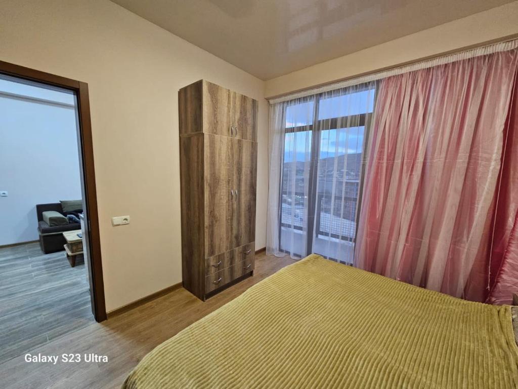 una camera con un letto e una grande finestra di My Sweet Home In Rustavi city 5 a Rustavi