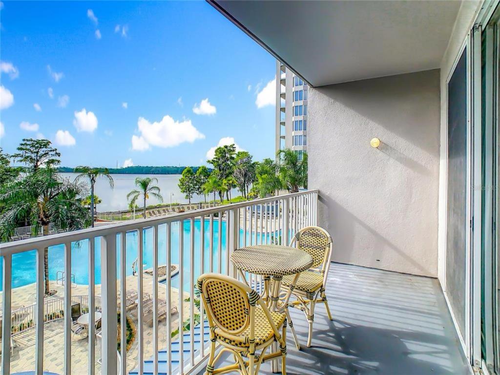 a balcony with a table and chairs and a view of the ocean at Disney just 1 and a quarter mile away, Blue Heron 1 room 2 bath,amenities,6 guests, walk to restaurants in Orlando