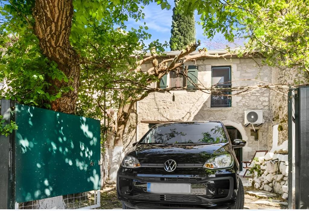 a car parked in front of a house at Tranquil Kolivata lefkada Retreat House in Alexandros