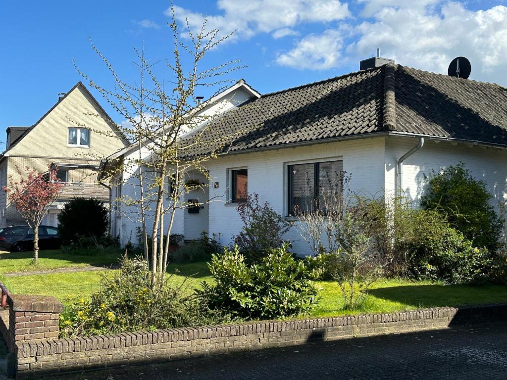 uma casa branca com um telhado preto em Entspannung am Niederrhein - großes helles Haus mit Kamin em Emmerich