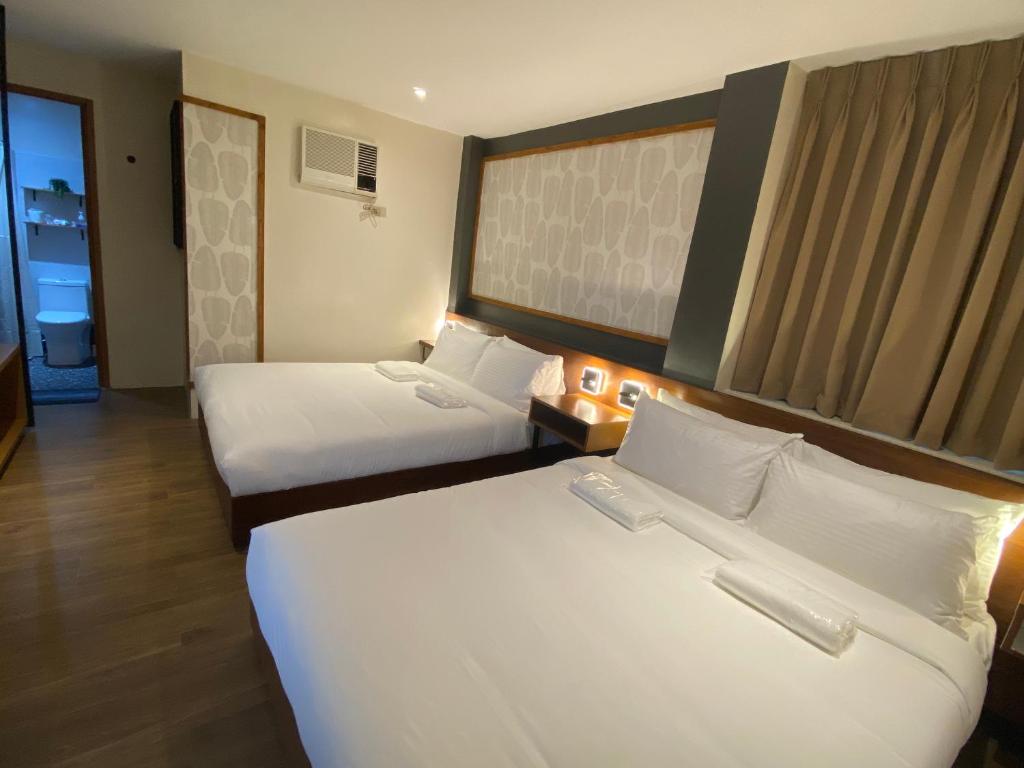 Postel nebo postele na pokoji v ubytování Jovinaj Travellers Inn