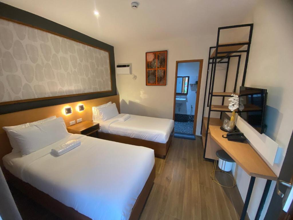 Postel nebo postele na pokoji v ubytování Jovinaj Travellers Inn