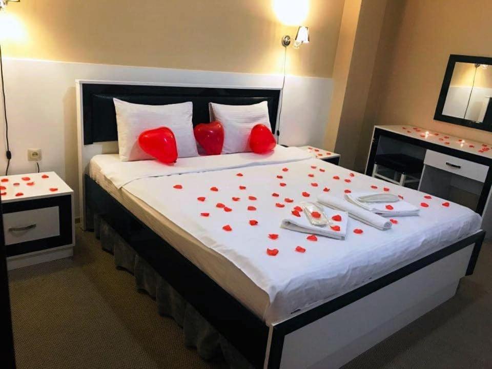 Un dormitorio con una cama grande con corazones rojos. en BATONI, en Tiflis