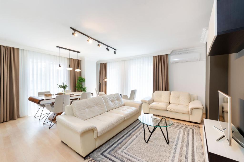 a living room with a white couch and a table at G&B MANSION in Istanbul