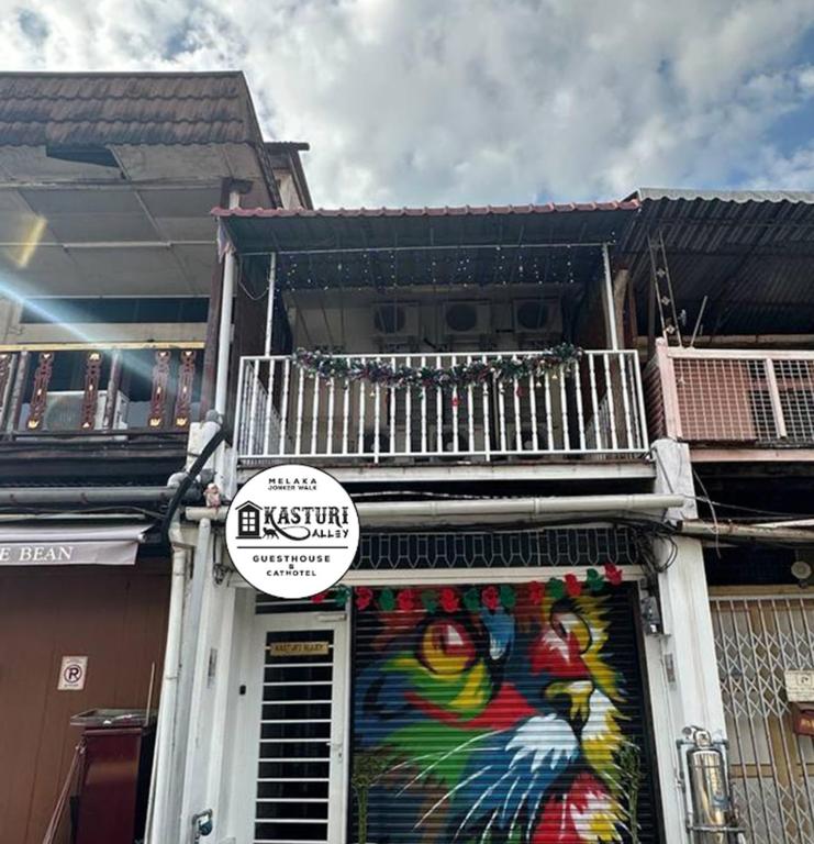 a store with a painting on the side of a building at SPOT ON 90898 Kasturi Alley Guest House & Cat Hotel in Melaka