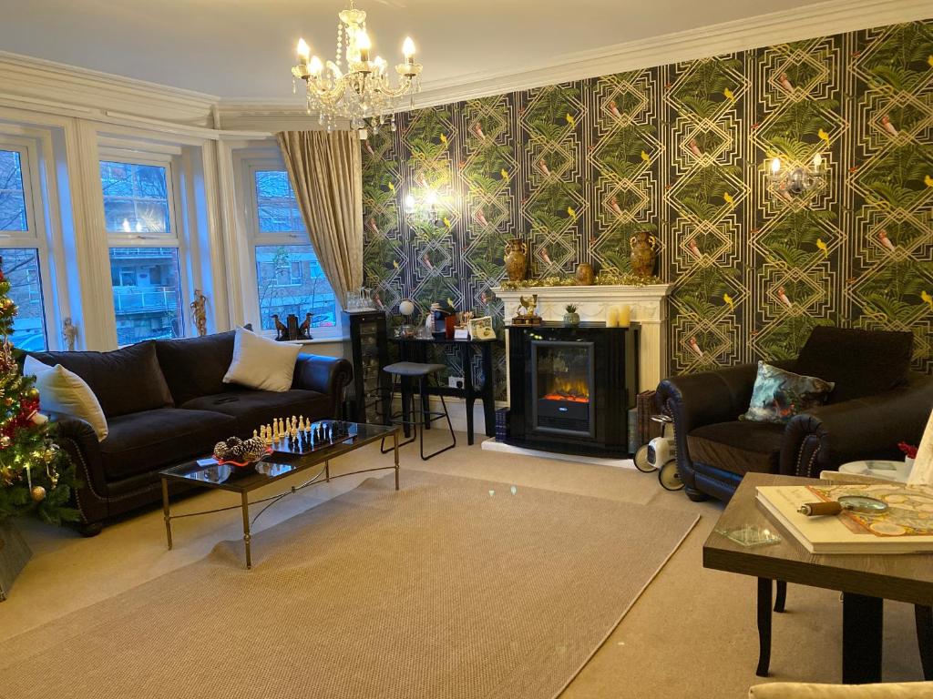 a living room with a couch and a fireplace at The Cherry Tree Guest House in Eastbourne
