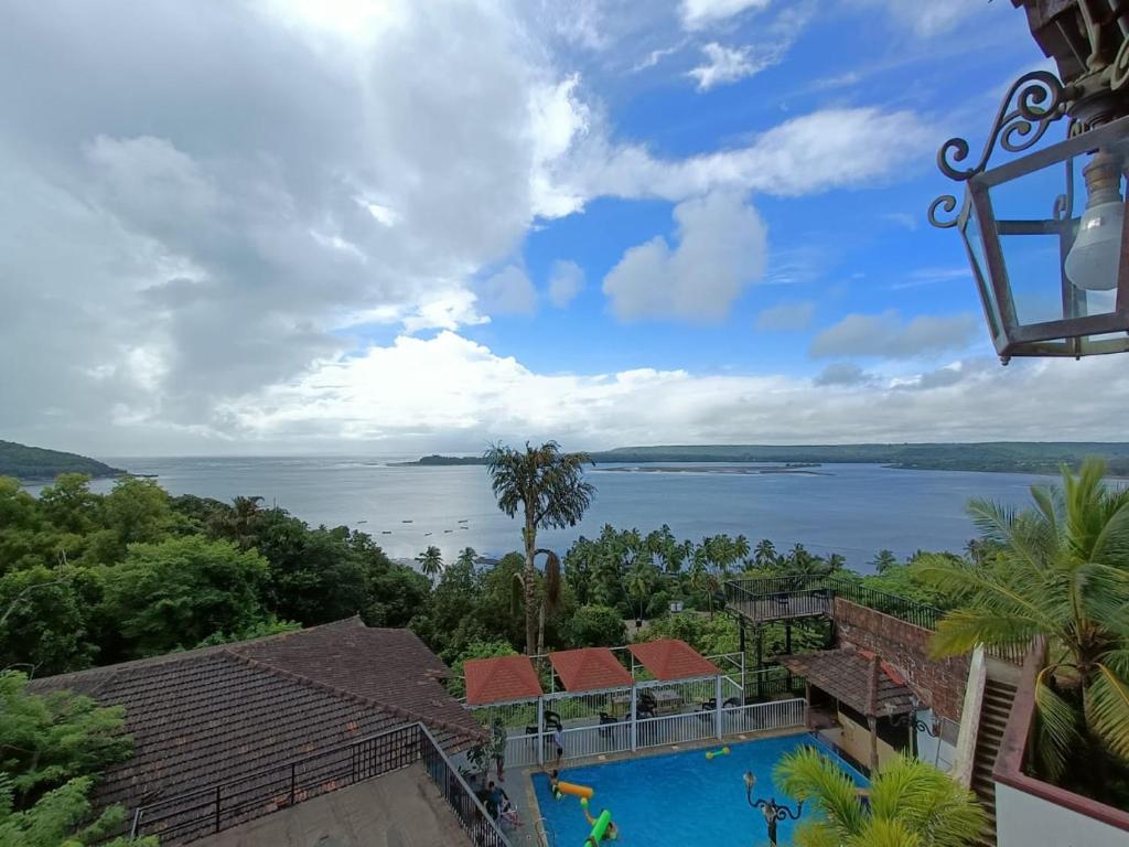 a view of the water from a house at Raposo Resorts in Vagator