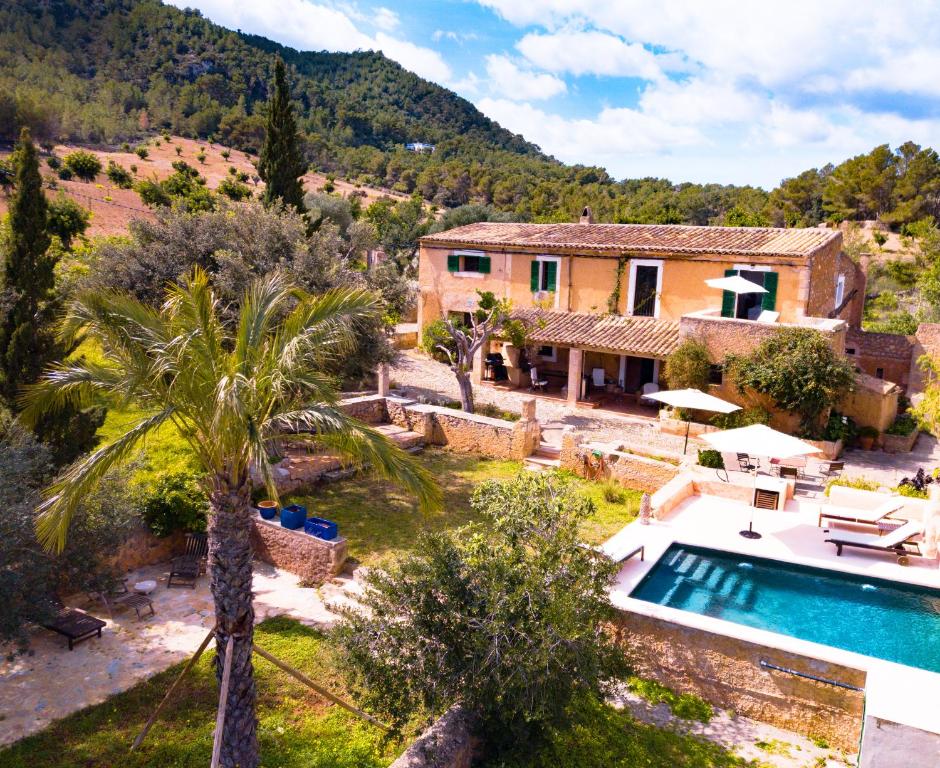 a villa with a swimming pool and a house at Finca CanFirella Portocolom in Felanitx