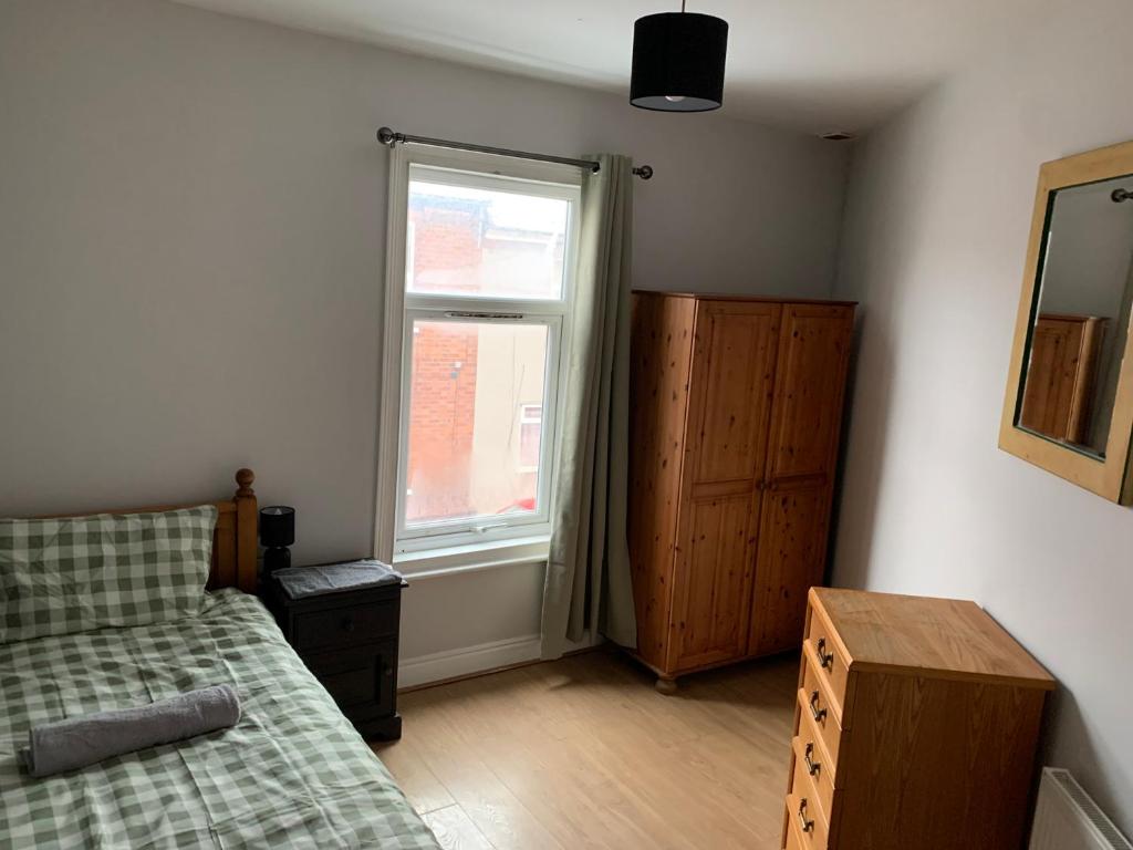 a bedroom with a bed and a window at M&B Accommodation in Lincoln