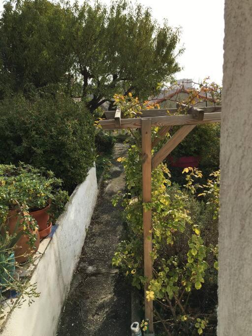 a wooden pergola with plants in a garden at FLC-Sea View-Jacuzzi-3 Bedrooms-8p-Parking for 2 cars in Marseille