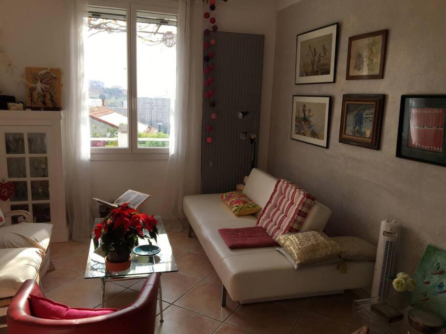 a living room with a white couch and a table at FLC-Sea View-Jacuzzi-3 Bedrooms-8p-Parking for 2 cars in Marseille