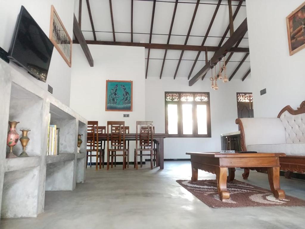 a living room with a couch and a table at Villa Conch by Om - Private House - Hikkaduwa in Hikkaduwa