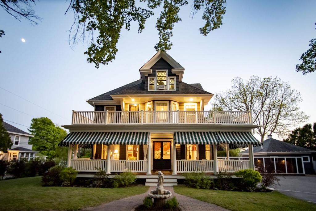 a house with a clock on the top of it at Lindenwood Inn in Southwest Harbor