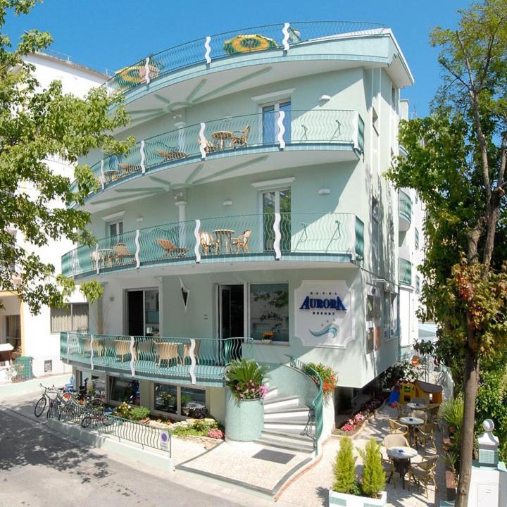 a large white building with birds on the balconies at HOTEL AURORA in Cattolica