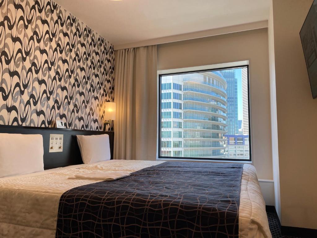 Postel nebo postele na pokoji v ubytování Bayside Hotel Azur Takeshiba