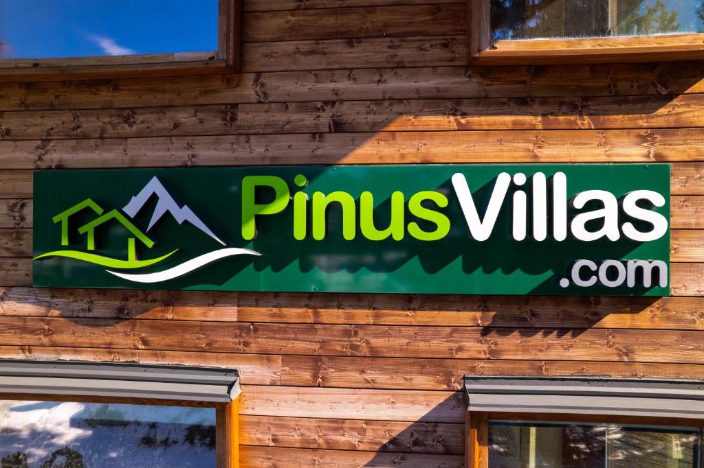a sign on the side of a building at Pinus Villas Lodge with Private Jacuzzi & Phyto-Sauna Retreat in Zheleznitsa