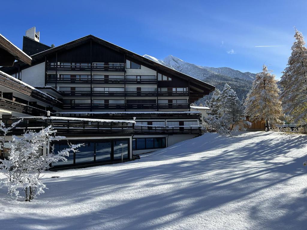 a large building in the snow in front at Appartementhaus Birkenwald in Seefeld in Tirol