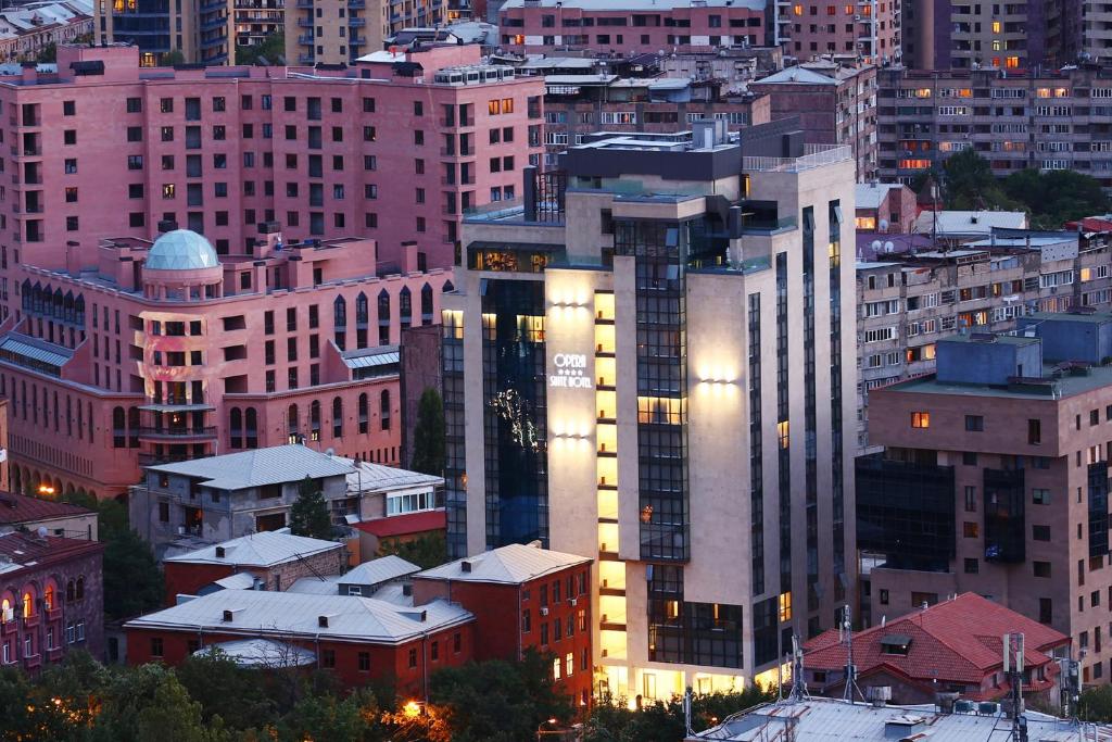 a group of tall buildings in a city at night at Opera Suite Hotel in Yerevan