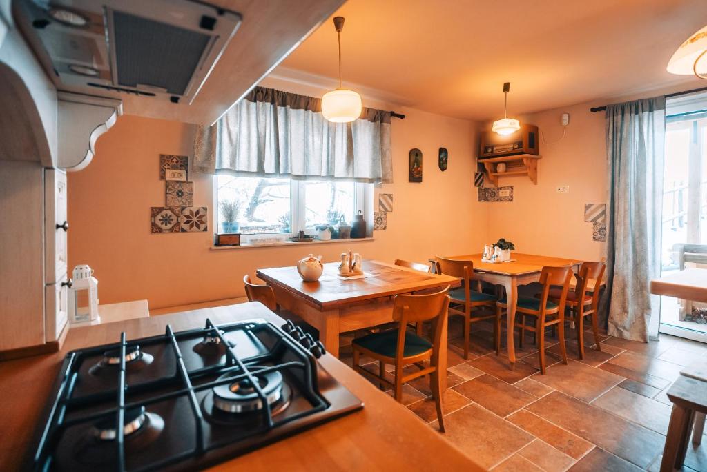 a kitchen and dining room with a stove and a table at Posest Kunigunda in Šmartno v Rožni Dolini