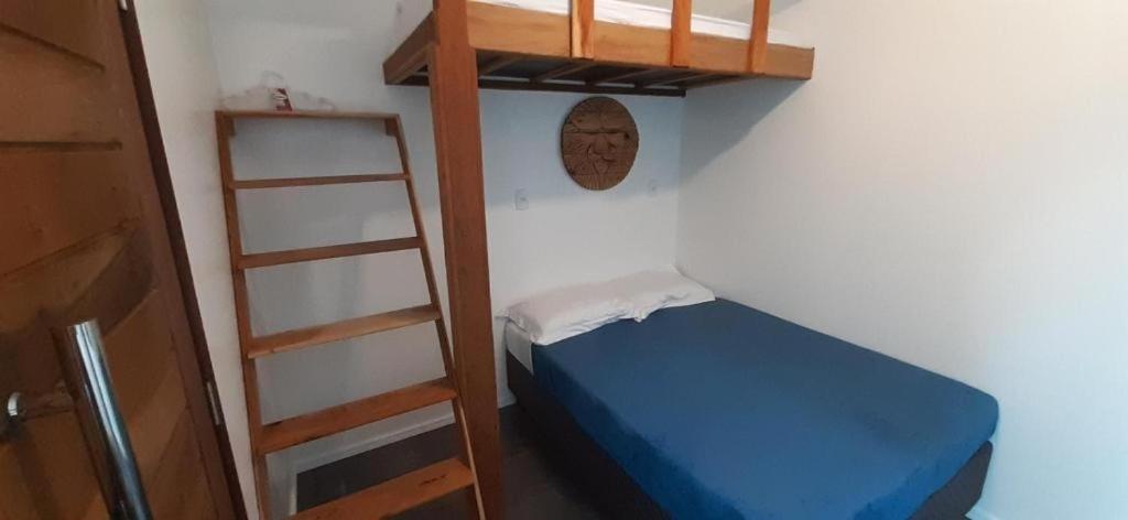 a bedroom with a bunk bed and a ladder at Pousada dos Ventos in Penha