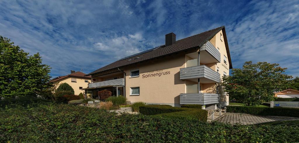 a building with a sign on the side of it at Hotel Garni Sonnengruss in Hagnau