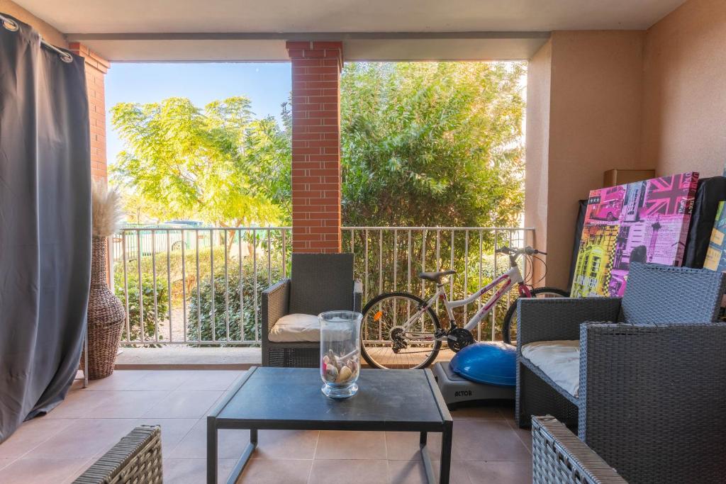 patio con mesa y balcón con bicicleta en Appartement zen en Cogolin