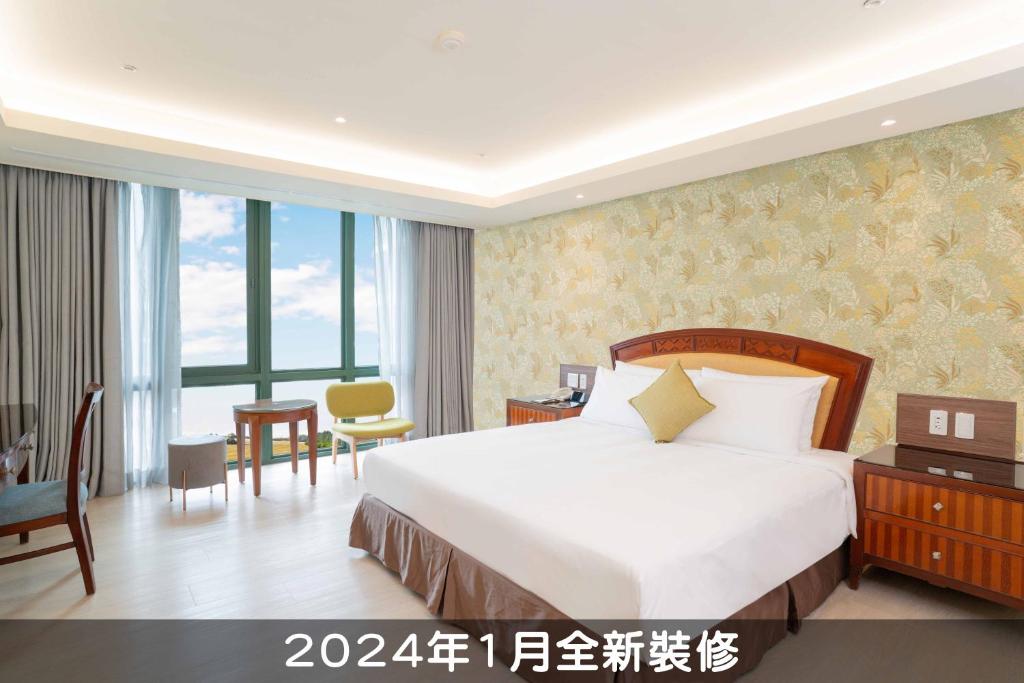 a hotel room with a bed and a desk and a room at Formosan Naruwan Hotel in Taitung City