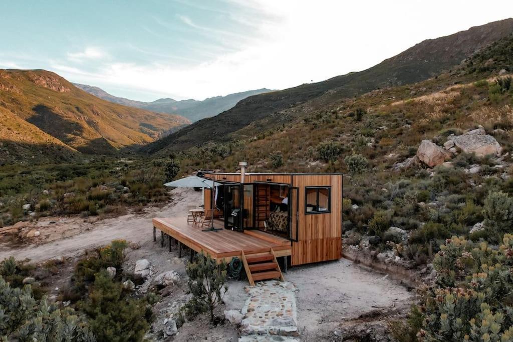 a small cabin in the middle of a mountain at Luxury Solace Cabin - River Cabin in Rawsonville