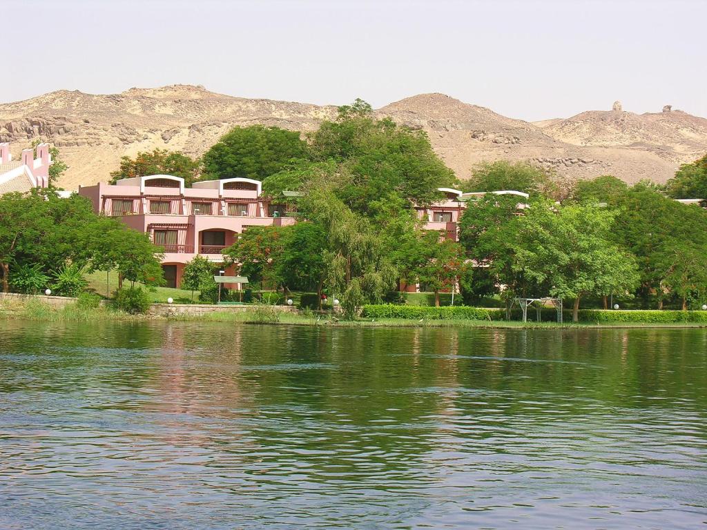 a group of houses next to a body of water at Pyramisa Island Hotel Aswan in Aswan