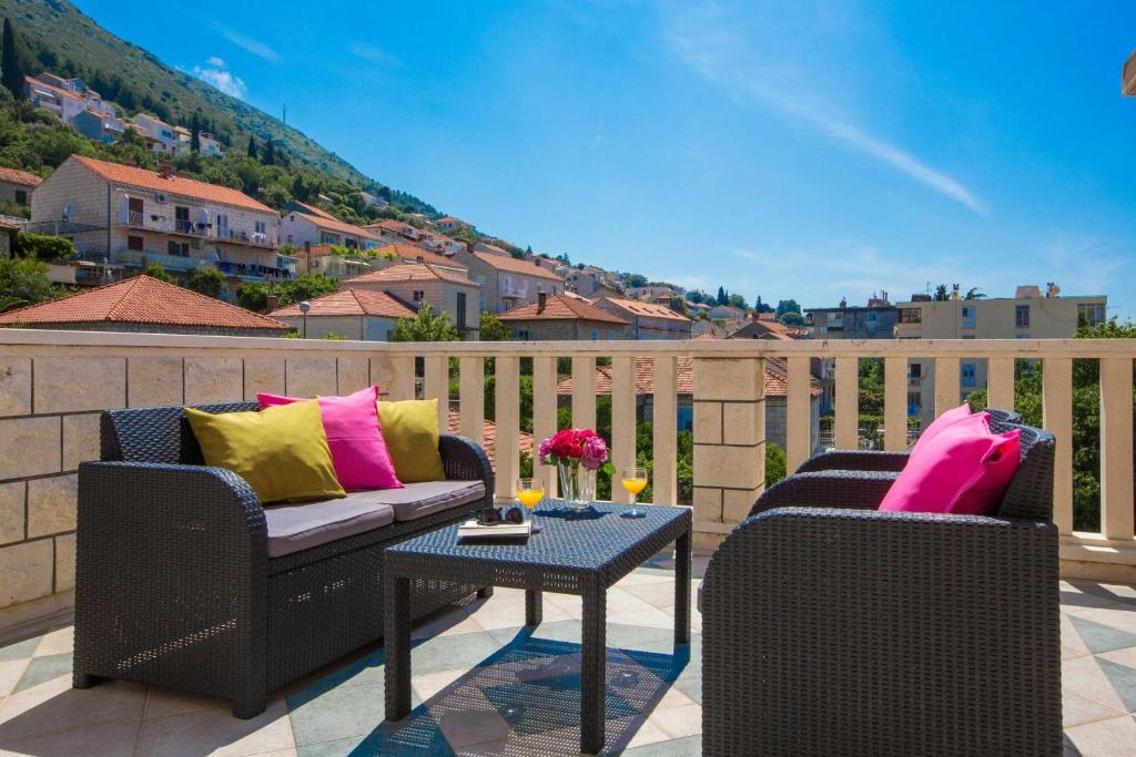 a patio with two chairs and a table on a balcony at City Apartments Lani in Dubrovnik