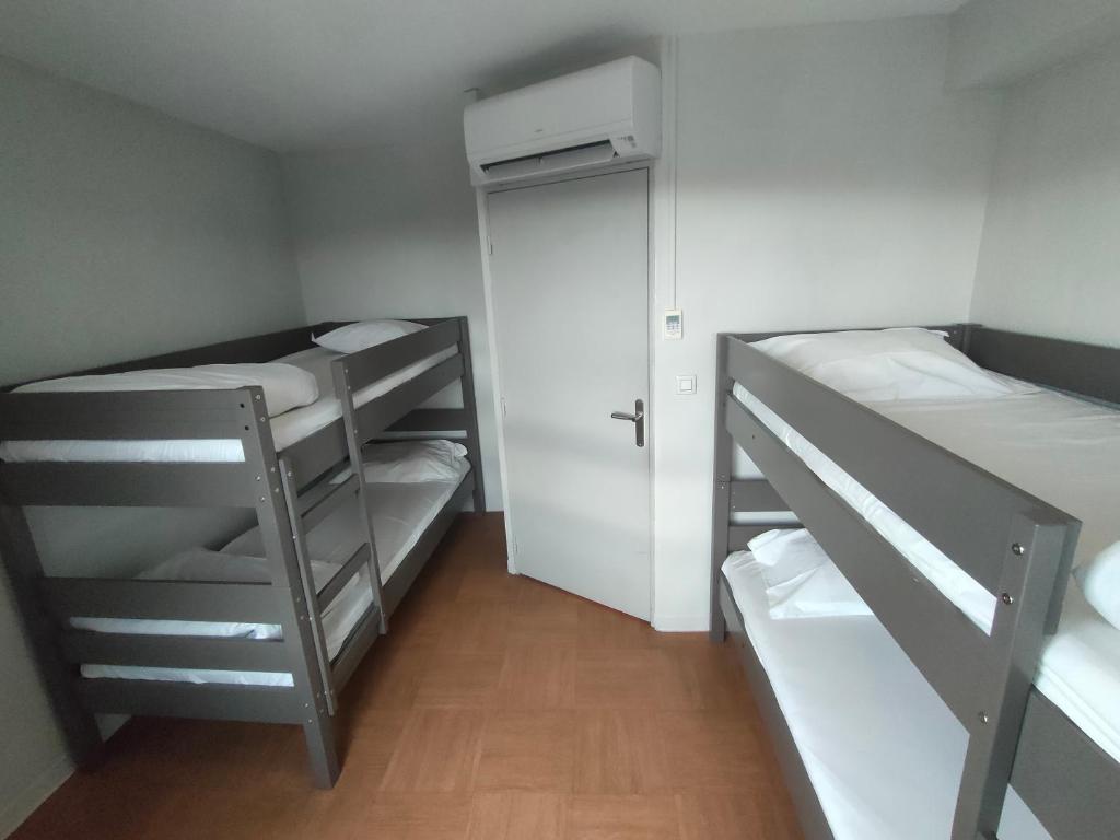 a small room with two bunk beds and a closet at ApartHotel Sainte-Marthe in Avignon