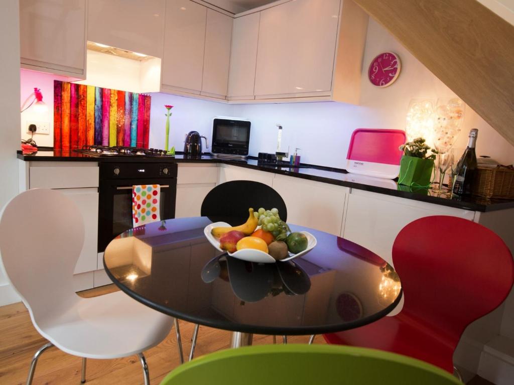a kitchen with a table with a bowl of fruit on it at 1 Bed in Richmond G0180 in Richmond