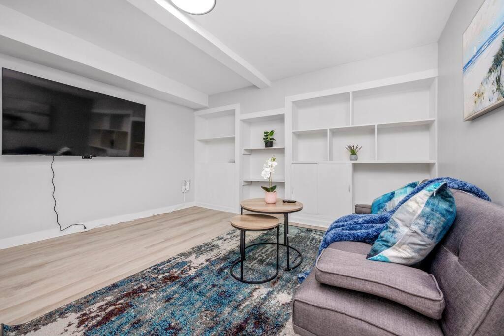 a living room with a couch and a table at CenterStreet-Cozy 2bedroomSuite in Calgary