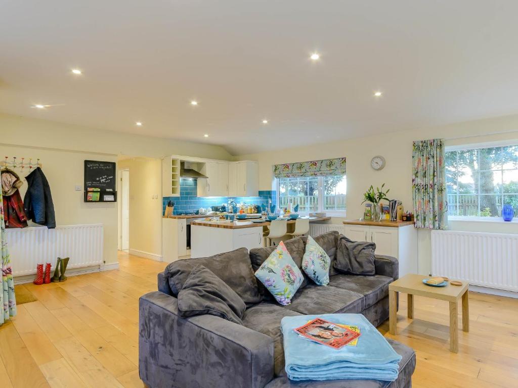 a living room with a couch and a kitchen at 1 Bed in Whatton 77805 in Bingham