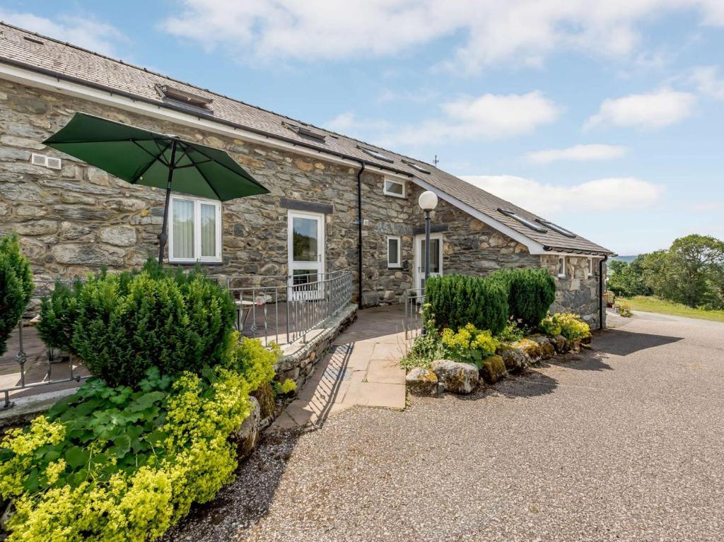 a stone cottage with an umbrella in front of it at 1 bed property in Bala North Wales 83765 in Llandderfel