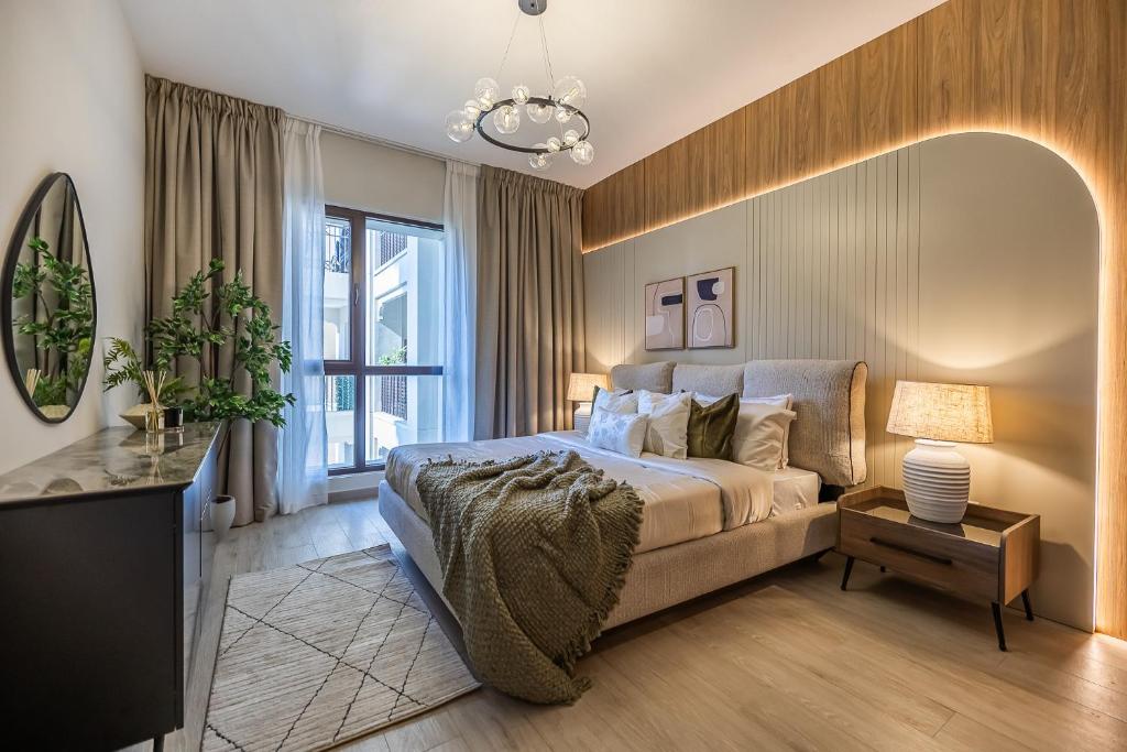 a bedroom with a bed and a large window at 1BDR in Madinat Jumeirah Living Close to Burj Al Arab in Dubai