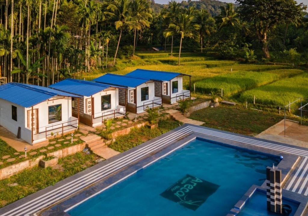 an aerial view of a house with a pool at Areca Jungle Stays by StayApart in Potolai