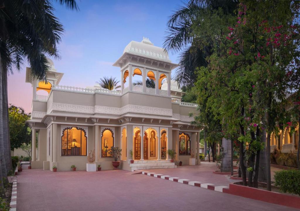 a large white building with a tower at jüSTa Rajputana Resort & Convention Centre, Udaipur in Udaipur