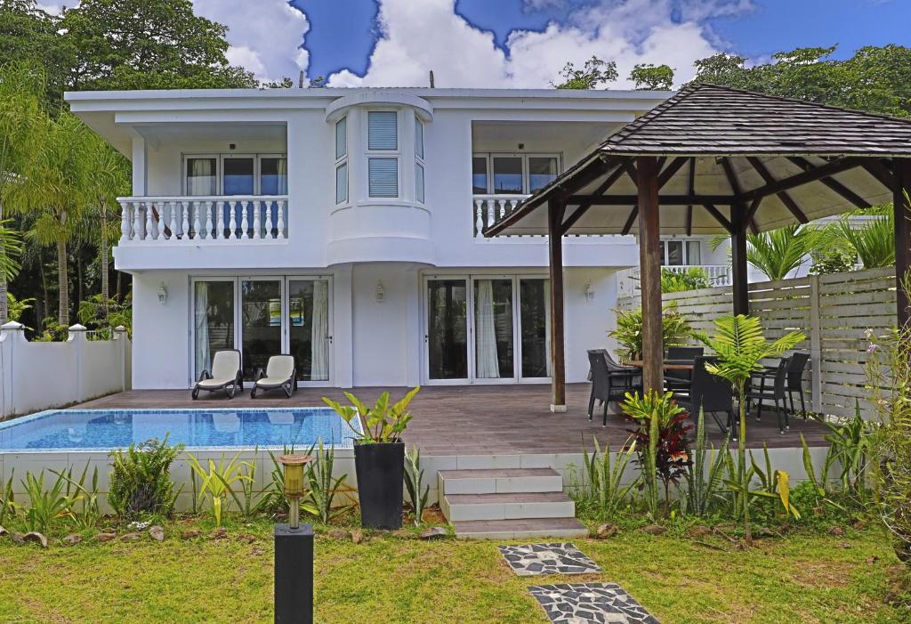 a villa with a swimming pool and a house at Chateau Elysium - Two bedroom villa 2 in Beau Vallon